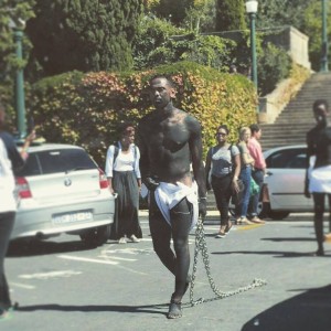 SaartjieBaartman // Man walking with Chains. Photo credit: UCT Rhodes Must Fall